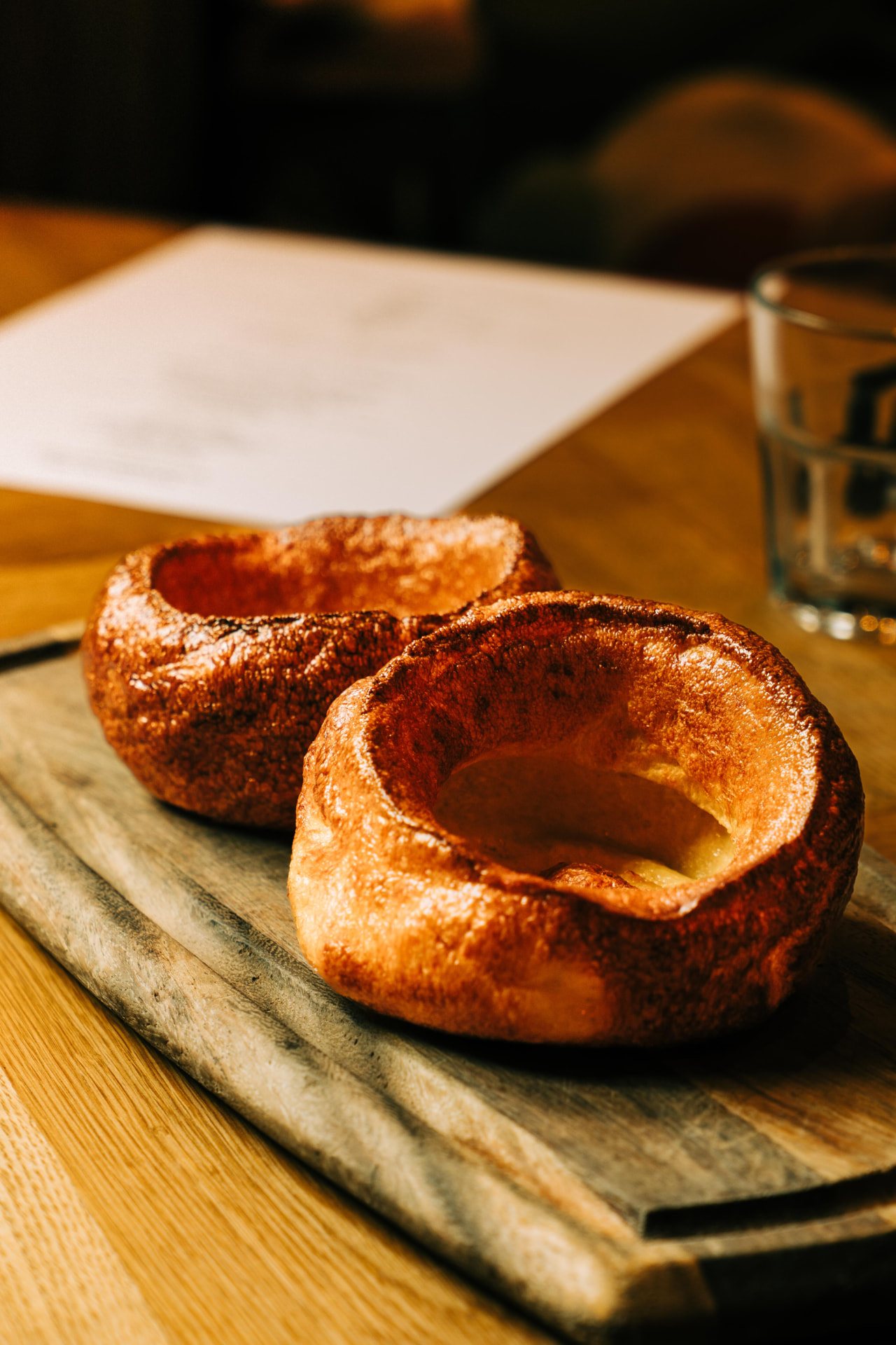 Yorkshire puddings fresh from the oven on a wooden board