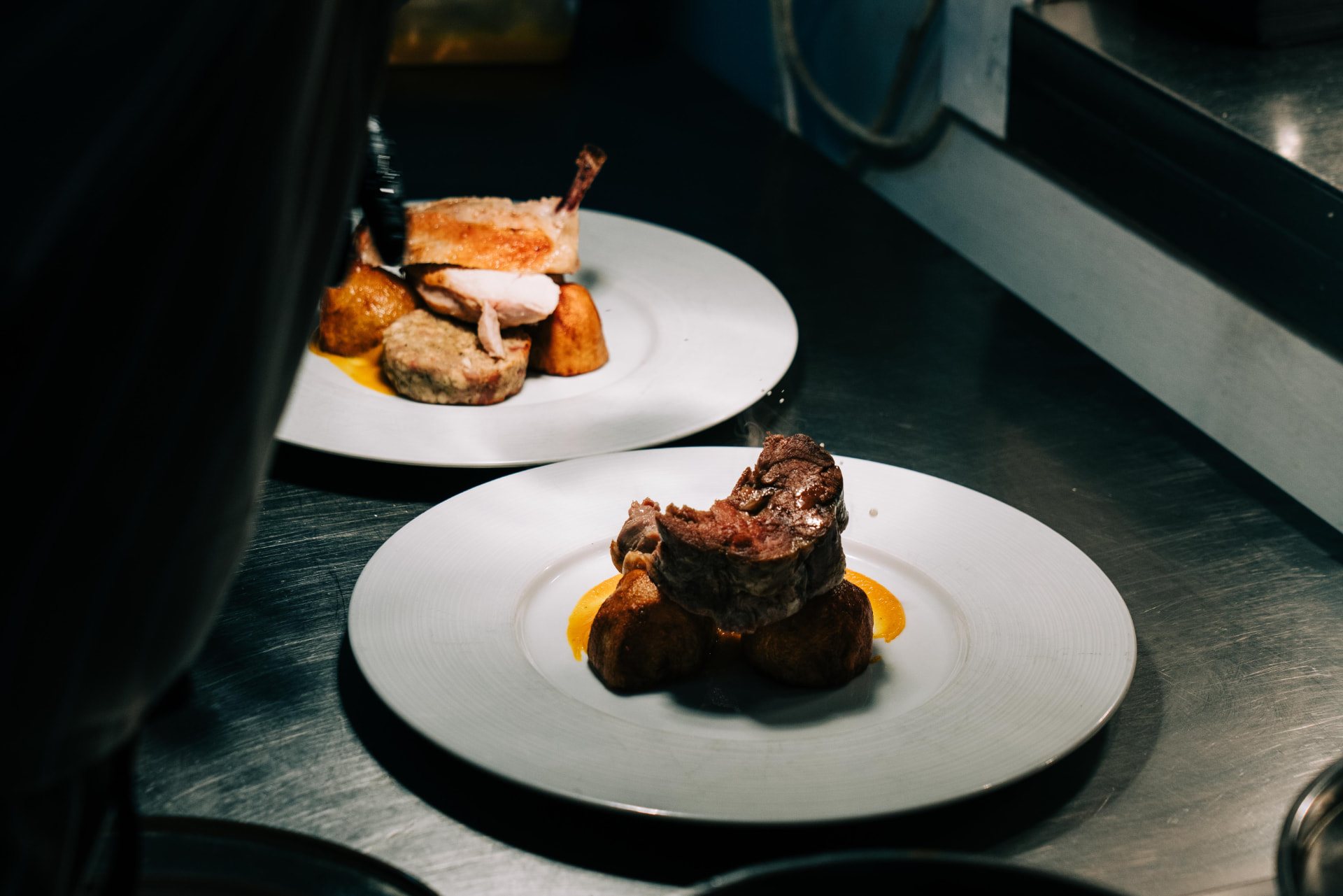 Main courses plated at the pass